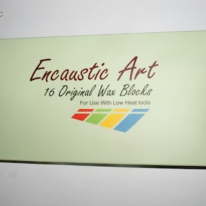 May include: A green box with the text "Encaustic Art" and "16 Original Wax Blocks" in brown lettering. The text "For Use With Low Heat Tools" is also printed on the box in brown lettering. A colourful logo of four overlapping rectangles is printed below the text.