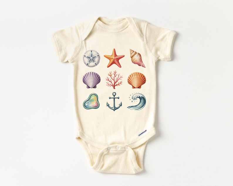 May include: Cream-colored baby onesie featuring watercolor illustrations of various sea elements. The design includes a starfish, seashells, coral, an anchor, and a wave. The illustrations are in shades of orange, purple, and blue.