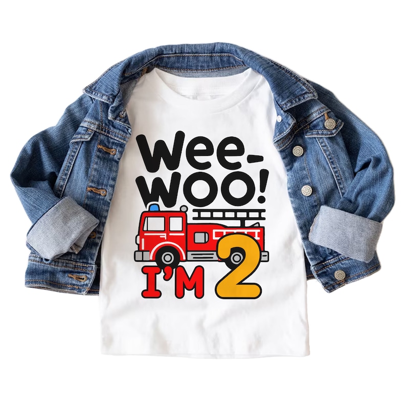 May include: White t-shirt with a red fire truck and the text "Wee-Woo! I'm 2" in black and yellow.