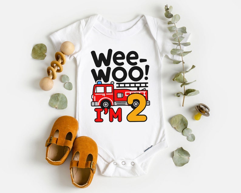 May include: White baby onesie with a red fire truck and the text "Wee-Woo! I'm 2".