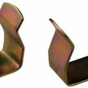 May include: Two gold metal clips, each shaped like a U, with rounded edges. The clips are designed to hold items together.