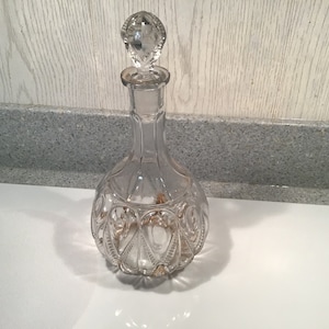 Vintage Clear Glass Decanter with round base with Glass Stopper and Gold Leaf accents. Unique design
