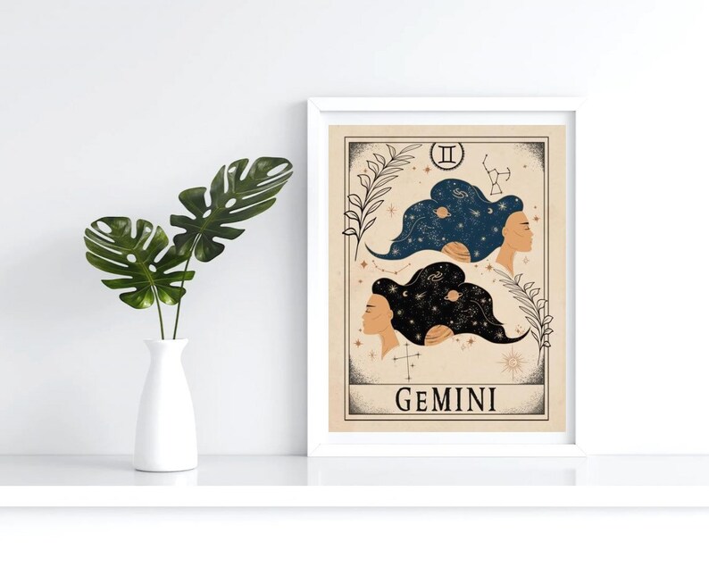 May include: A beige and brown illustrated print of the Gemini zodiac sign. The illustration features two women with their hair styled as constellations. The text "GEMINI" is printed below the illustration.