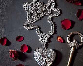 Gothic medieval heart shaped locket with a bat detail extended from an ornate charm holder.