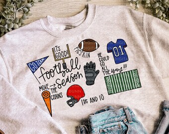 May include: A gray sweatshirt with a football theme design. The design includes the words "It's Good!" "Pigskin" "He Could Go All The Way!" "Go Team" "Football Season" "Move The Chains" "1st and 10" "Touchdown" and a football, helmet, glove, and jersey.