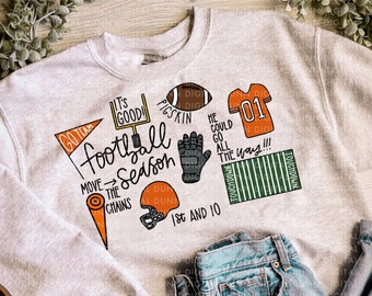 May include: A gray sweatshirt with a football theme. It features the text "Go Team", "It's Good!" and "Football Season". There are also images of a football, a football glove, a football jersey, and a football field.