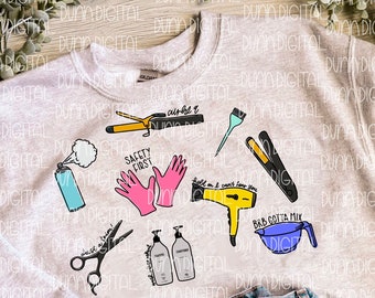 May include: A gray sweatshirt with a design of hairdressing tools and text that says "Safety First", "Curly As", "Hold on I can't hear you", "Dust a Trim", and "BRB Gotta Mix".