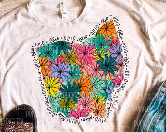 May include: A white t-shirt featuring a floral design in the shape of the state of Ohio. The design incorporates a range of colours, including pink, orange, yellow, green, and blue. The words "Ohio" are repeated around the design.