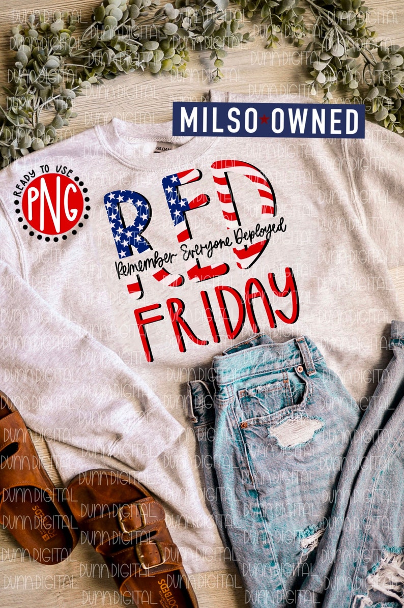 May include: A gray sweatshirt with a red, white, and blue graphic that says "RED" with the letters made of the American flag. The text "Remember Everyone Deployed" is written below the word "RED" and the word "FRIDAY" is written below that. The sweatshirt is laying on a wooden surface with a pair of brown sandals and a pair of blue jeans.