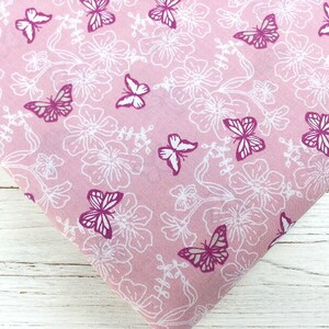 May include: Pink fabric with a white floral pattern and pink butterflies.