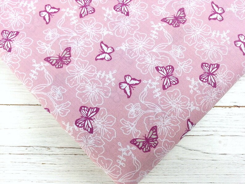May include: Pink fabric with a white floral pattern and pink butterflies.