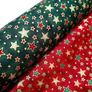 May include: Two fabric swatches with a repeating pattern of gold, red, and green stars on a green and red background.