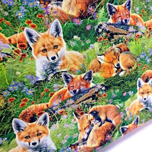 May include: A colorful fabric featuring a repeating pattern of red foxes in a field of green grass and wildflowers. The foxes are in various poses, including sleeping, playing, and looking at the viewer. The fabric is perfect for crafting projects, such as quilts, pillows, and bags.