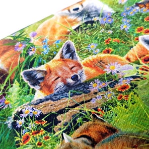 May include: A colorful fabric featuring a repeating pattern of foxes sleeping in a field of flowers. The foxes are orange, brown, and white, and the flowers are pink, purple, blue, and yellow.
