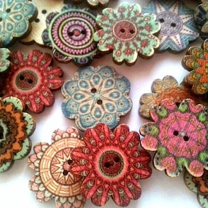 May include: Assortment of colourful wooden buttons with intricate floral designs. Each button features a two-hole design and a variety of colours, including blue, green, red, orange, and pink.