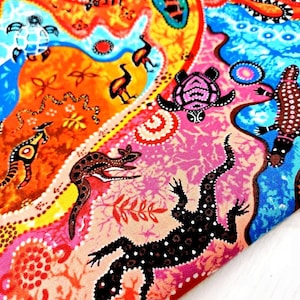 May include: A colourful fabric with an Aboriginal art design. The pattern includes stylized depictions of animals such as lizards, turtles, and kangaroos, set against orange, pink, and blue hues. The artwork is rich in detail, with dot patterns and organic shapes.