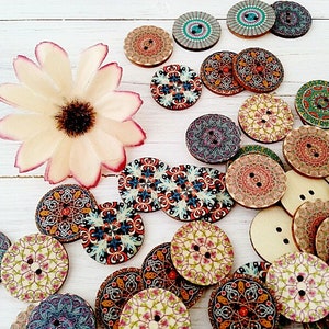 May include: Assortment of colourful wooden buttons with intricate patterns. The buttons are round and feature various designs, including floral, geometric, and abstract motifs.