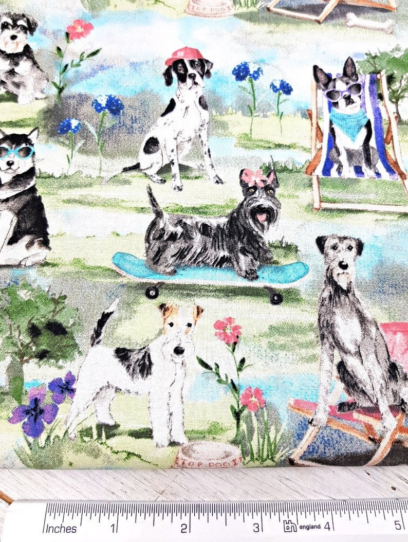 May include: Fabric with a repeating pattern of various dog breeds in a park setting. The dogs are depicted in different poses, some wearing sunglasses or hats. The background includes flowers, trees, and a blue sky, creating a whimsical and colorful design.