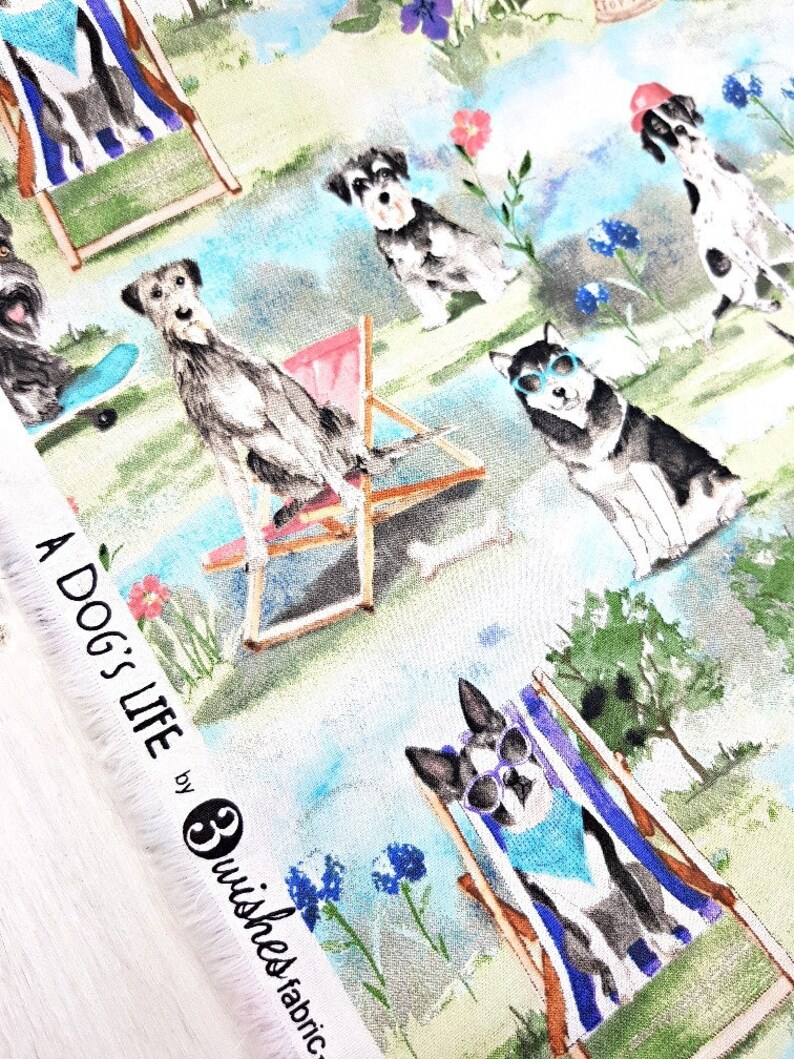 May include: Fabric with a whimsical print featuring dogs enjoying leisure activities. Dogs are depicted in sunglasses and beach chairs, with the text "A Dog's Life" visible. The background includes flowers and a blue sky.