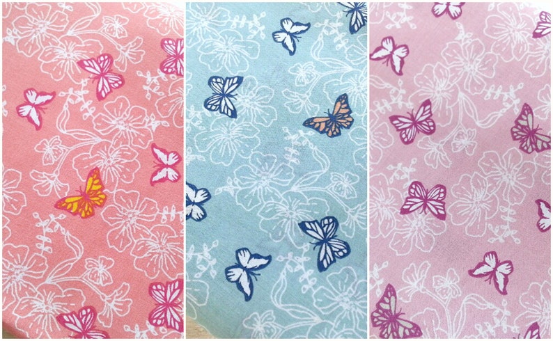 May include: Three fabric swatches with a white floral and butterfly pattern. The swatches are pink, light blue, and light pink.