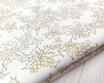 May include: White fabric with a gold holly leaf and berry pattern.