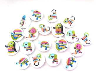 May include: A collection of round white buttons featuring colorful, striped animal illustrations. The designs include penguins, snails, elephants, turtles, and monkeys, each rendered in vibrant rainbow hues with two small holes for sewing.