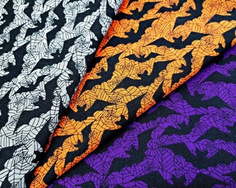 May include: Three fabric swatches with a black background and a repeating pattern of bats and spiderwebs. The swatches are white, orange, and purple.