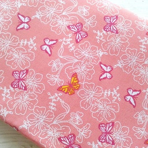 May include: Pink fabric with a white floral pattern and colorful butterflies. The fabric is perfect for crafting projects, quilting, and sewing.