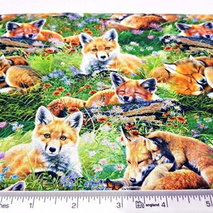 May include: A colorful fabric featuring a repeating pattern of red foxes in a grassy meadow with wildflowers. The foxes are in various poses, including sleeping, sitting, and standing.