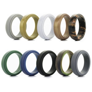 May include: A collection of ten silicone rings in various colors, including gray, olive green, white, and camouflage patterns. Each ring has a grooved design and the text "KEEP FIT" is visible on some rings.