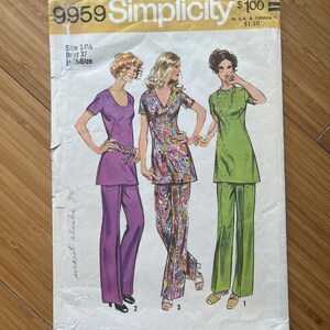 May include: Simplicity sewing pattern number 9959 for a dress and pants. The pattern includes three different styles: a purple dress and pants, a floral print dress and pants, and a green dress and pants. The pattern is for size 14 1/2, bust 37. The price is $1.00.
