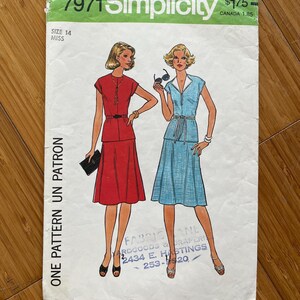 May include: Simplicity sewing pattern number 7971 for a dress, size 14 miss. The pattern shows two women wearing the dress in red and blue. The pattern is priced at £1.75.