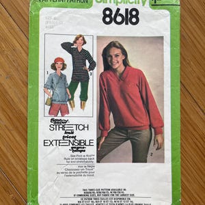 May include: Simplicity sewing pattern number 8618 for knit tops in sizes 8, 10, and 12. The pattern includes instructions for three different styles of tops, including a striped top with a V-neck, a red top with a V-neck, and a blue top with a scoop neck. The pattern is labelled "Time-Saver Stretch Knit Tricot Extensible Fabrics".