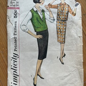 May include: Vintage Simplicity sewing pattern for a sleeveless vest and skirt. The pattern is for size 14, bust 34. The pattern is printed on a white background with black text and illustrations of two women wearing the garments. The vest is green and the skirt is plaid.