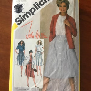May include: Simplicity sewing pattern number 5438 for a skirt and jacket. The pattern is for a young woman and features a white blouse, a red jacket, and a gingham skirt. The pattern is by John Weitz.