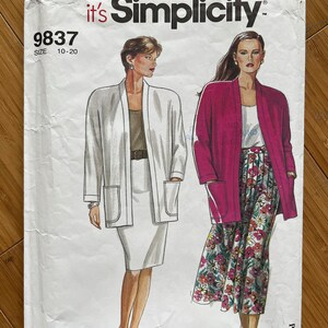 May include: Simplicity sewing pattern number 9837 for sizes 10-20. The pattern includes instructions for making a long-sleeved jacket with pockets and a skirt. The model on the left is wearing a white jacket and skirt, while the model on the right is wearing a pink jacket and a floral skirt.