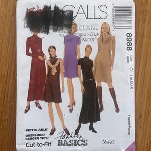 May include: A McCall's 8988 sewing pattern envelope for dresses in sizes 10, 12, and 14. The front features illustrations of five different dress styles in various lengths and colors, including maroon, brown, purple, black, and tan, with text.