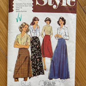 May include: Vintage sewing pattern for a skirt, featuring three women wearing different styles of skirts. The pattern is for sizes 10-12, 14-16, 18-20, 40-42, and 44-46. The pattern is called "Style" and is number 2475.