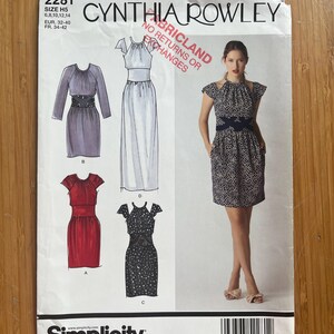 May include: A Simplicity sewing pattern featuring Cynthia Rowley designs. The pattern includes illustrations of several dress styles, with a woman modeling one. The pattern size is H5, with measurements in EUR and FR sizes. The pattern number is 2281.