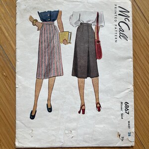May include: Vintage McCall's sewing pattern for a misses' skirt. The pattern number is 6867 and the price is 35 cents. The pattern is printed on white paper with a black and white illustration of two women wearing the skirt.