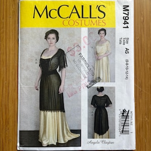 May include: McCall's Costumes sewing pattern M7941 for a long dress with a black lace overlay and a cream-coloured underskirt. The pattern is for sizes A5 (6-8-10-12-14).