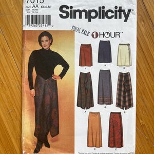 May include: Simplicity sewing pattern number 7015 for a wrap skirt. The pattern includes instructions for making seven different styles of skirts, including a long, flowing skirt with a wrap design, a shorter skirt with a ruffle, and a plaid skirt. The pattern is labeled "Final Sale 1 Hour".
