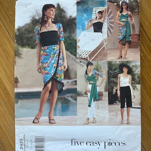 May include: A sewing pattern for five easy pieces of clothing. The pattern includes a wrap skirt, a top, a jacket, and two pairs of pants. The pattern is printed on white paper with black text and illustrations.