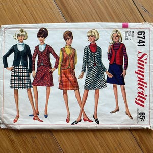 May include: Vintage Simplicity sewing pattern envelope with illustrations of five women in different outfits. The outfits include skirts, jackets, and waistcoats in various patterns and colours. The envelope has the number 6741 and the word "Simplicity" printed on it.