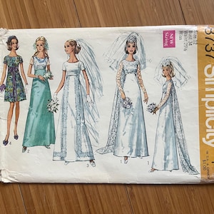 May include: Simplicity sewing pattern number 3737 for a wedding dress. The pattern includes four different styles of wedding dresses, all with long sleeves and a fitted bodice. The pattern is for sizes 12, bust 34 inches, waist 25 1/4 inches, for misses.