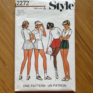 May include: Vintage sewing pattern for a skirt, featuring four women wearing different styles of skirts. The pattern number is 2272 and the size is 10 with a 25 inch waist. The pattern is titled "Style" and is labeled "One Pattern Un Patron".