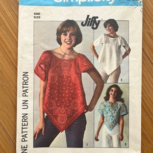 May include: Simplicity sewing pattern 7877 for a Jiffy top. The pattern includes three different styles of tops, one with a red bandana print, one with a white top, and one with a blue bandana print. The pattern is for one size.