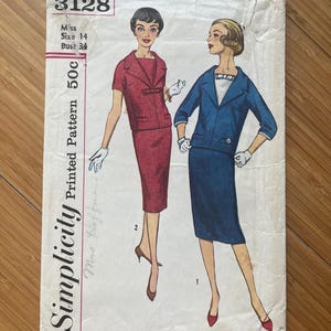 May include: Vintage Simplicity sewing pattern number 3128 for a dress with a jacket. The pattern is for a size 14 with a 34 inch bust. The pattern is for a miss and costs 50 cents.