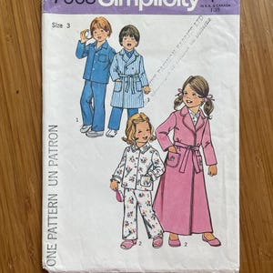 May include: Simplicity sewing pattern number 7068 for children's pyjamas and dressing gowns. The pattern includes three different styles: a blue pyjama set, a striped dressing gown, and a floral pyjama set. The pattern is for size 3.