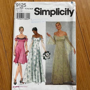 May include: Simplicity sewing pattern number 9125 for sizes 14, 16, 18, and 20. The pattern includes instructions for making two dresses. One dress is pink and the other is green with a floral print. The pattern is for a dress with a scoop neck and a gathered skirt. The pattern also includes instructions for making a matching sash.